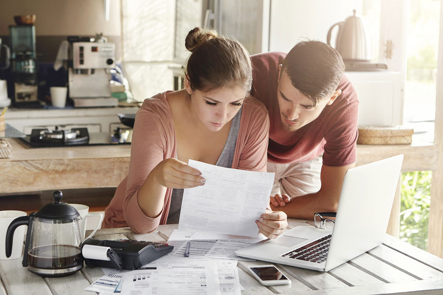 couple reviewing documents together at a home kitchen table