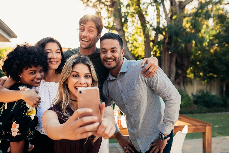 group taking selfie outdoors at a garden gathering