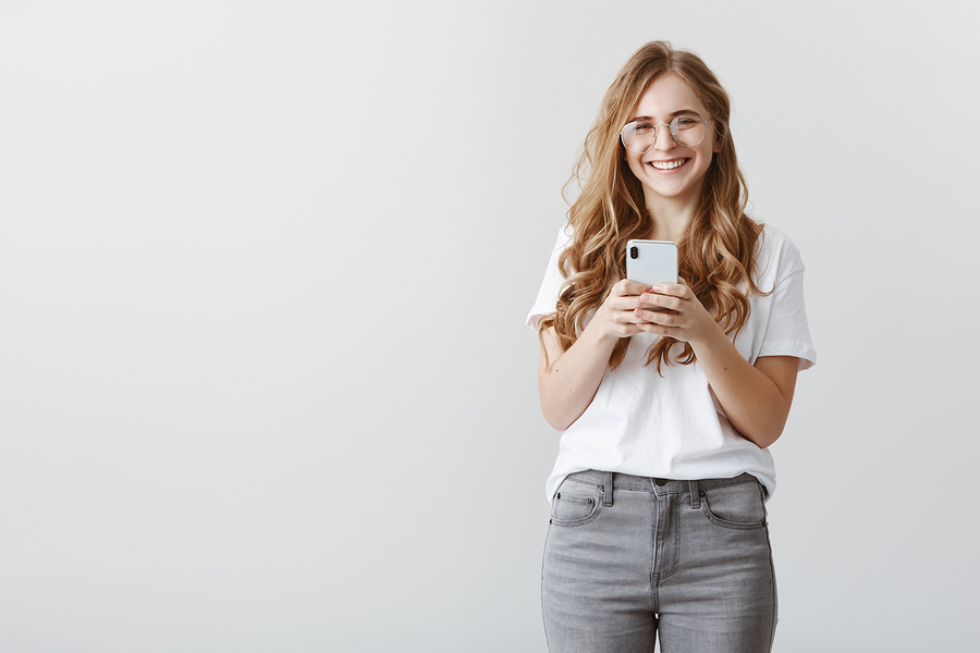 woman texting on smartphone in casual jeans and t-shirt