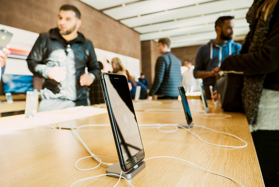 smartphones displayed on wooden table at the brand store