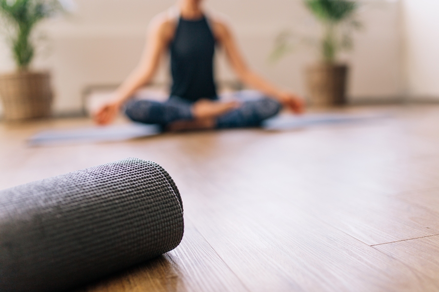 yoga mat resting as person meditates in serene room