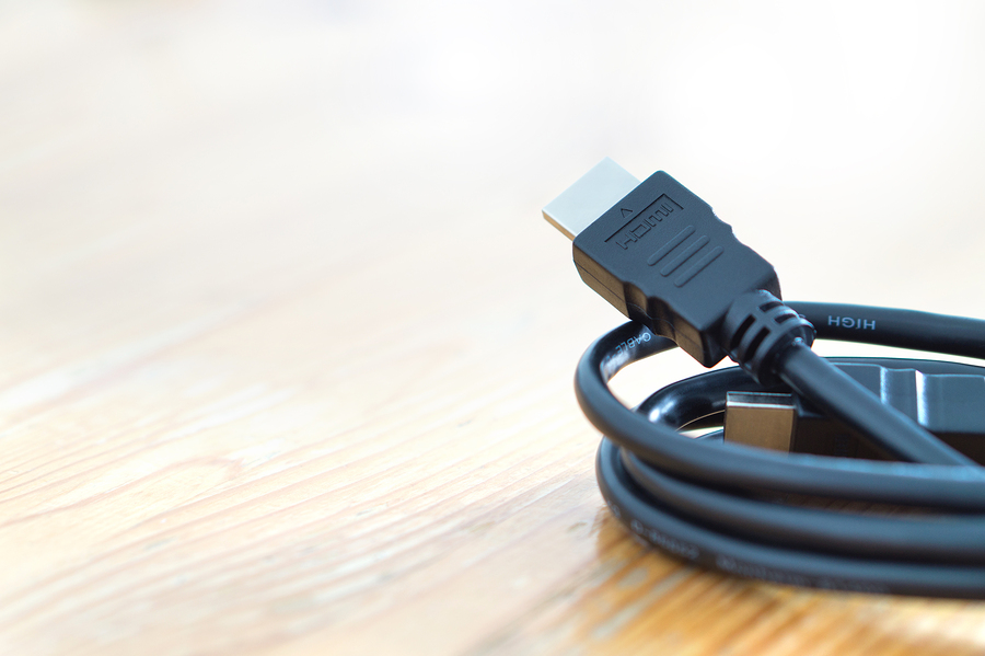 hdmi cable resting on wooden table surface.