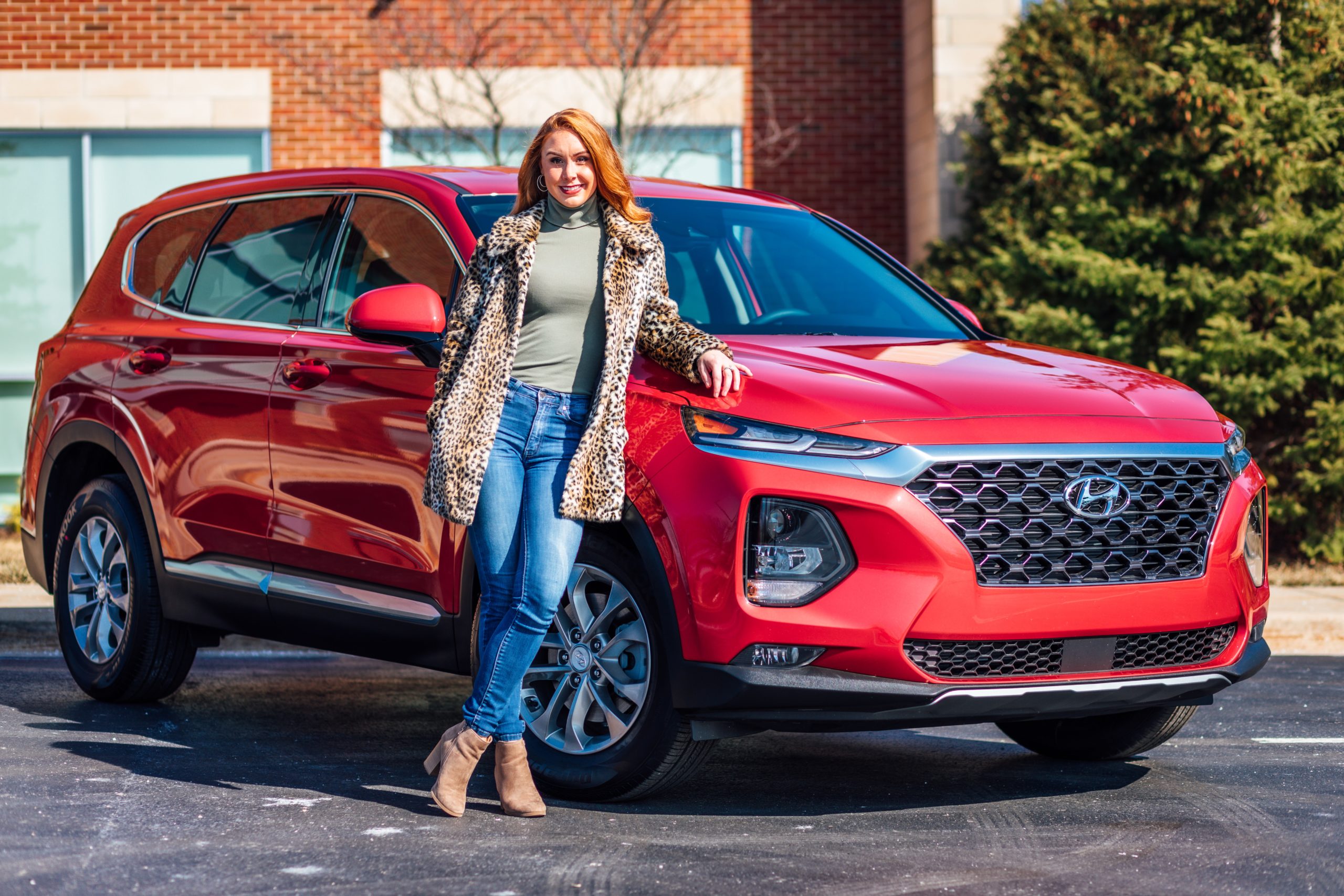 Woman standing in front of new car