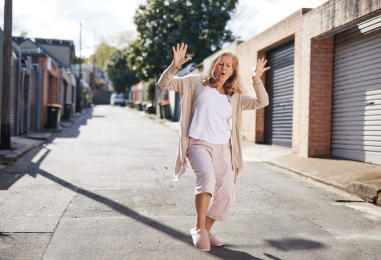 woman dancing joyfully on a quiet suburban street