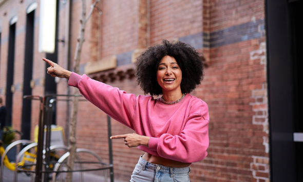 Woman pointing to the left enthusiastically