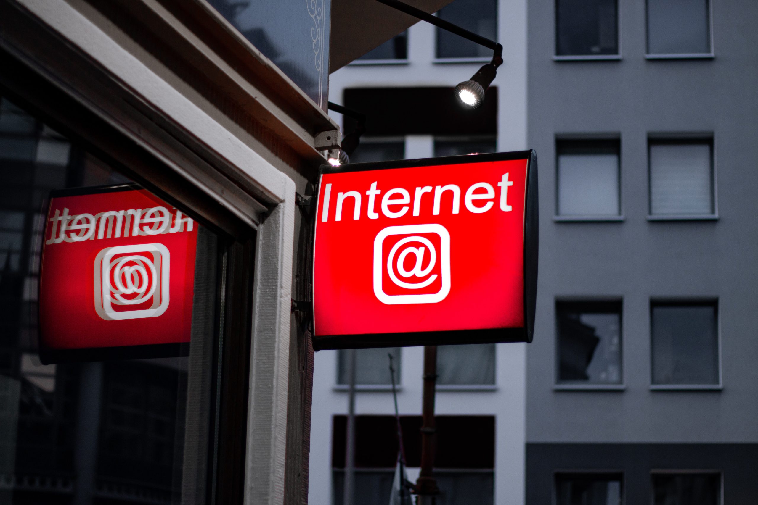 red internet sign glowing on urban building facade