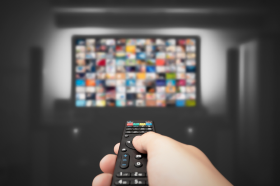 remote controlling tv with colorful streaming options on the screen