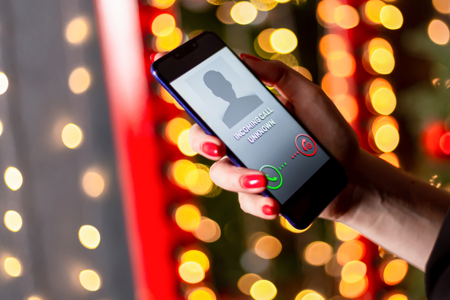 phone displaying unknown call in festive lighting background