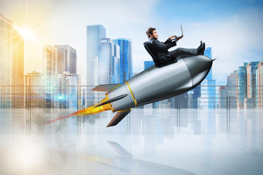 man using laptop while riding rocket in cityscape.