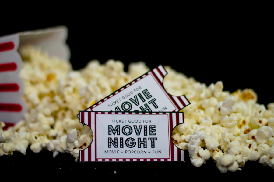 movie tickets lying on scattered popcorn for movie night