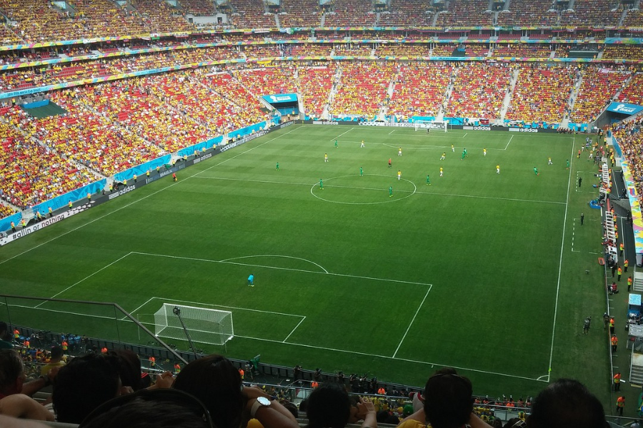 soccer players competing in a crowded stadium during a lively match.