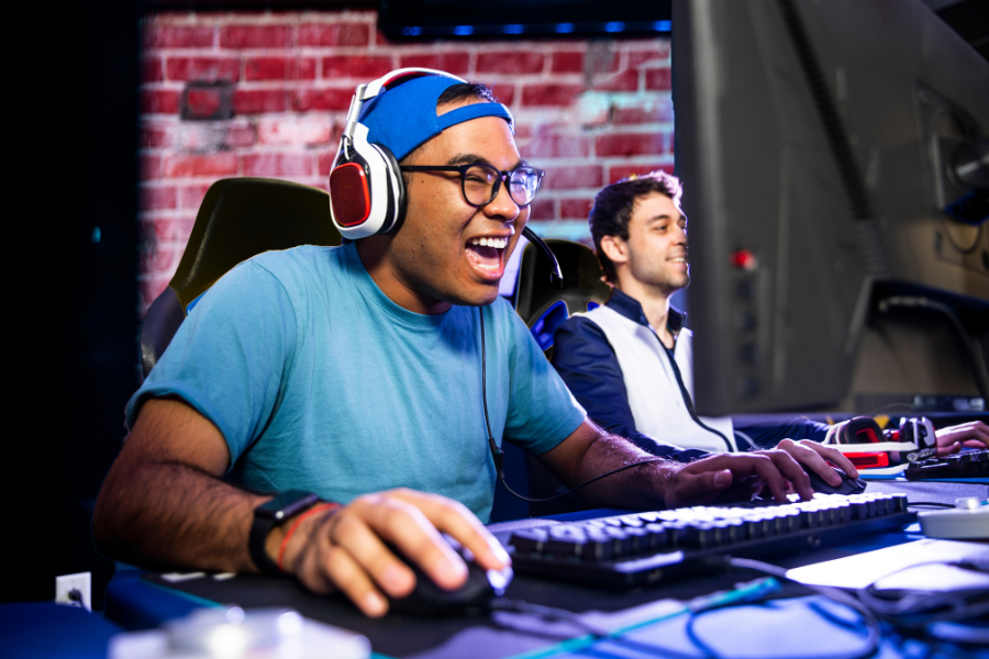 gamer laughing while playing video game in a competitive setting