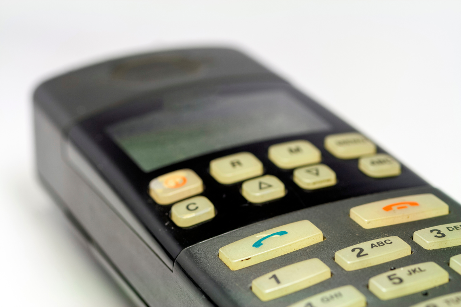 close-up of retro keypad phone on white surface