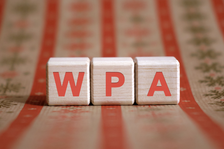 wooden blocks displaying 'wpa' on patterned tablecloth