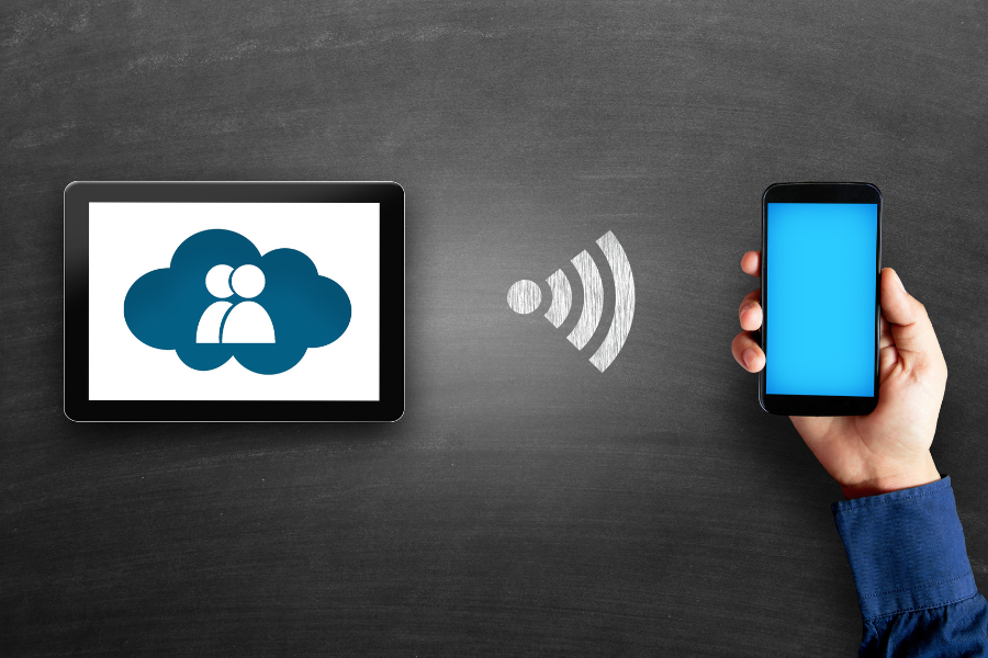 tablet displaying cloud icon connects with smartphone screen via wifi