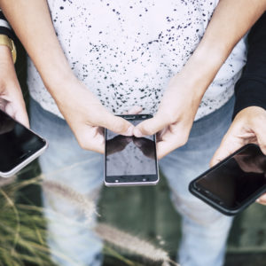 Group Of People Using Their Phones With Green Background Happy